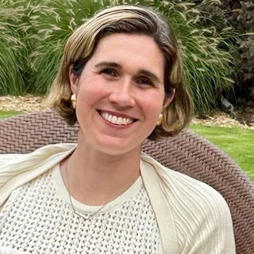 A photo of a Remitly employee, smiling and looking at the camera.
